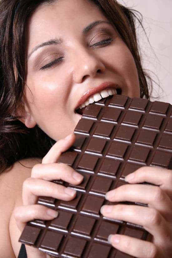 Cute lady munching off a chocolate tablet. Little does she know that it doesn't have any aphrodisiac effect whatsoever.