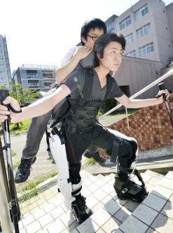 University postgraduate student Hiromasa Hara displays the Hybrid Assistive Limb climbing model, a robot suit designed to carry a person.