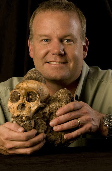 Prof. Lee Berger with the Australopithecus sediba cranium.
