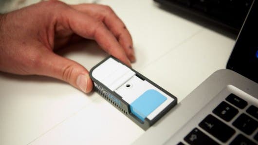 MinION portable DNA sequencing device plugged to the USB port of a laptop