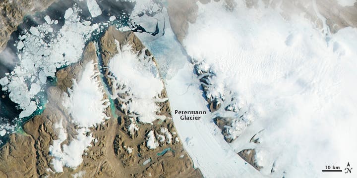 Satellite photo of the Petermann glacier before the giant iceberg broke off the ice sheet. Notice a significant crack shaped like a circle arc. (c) NASA