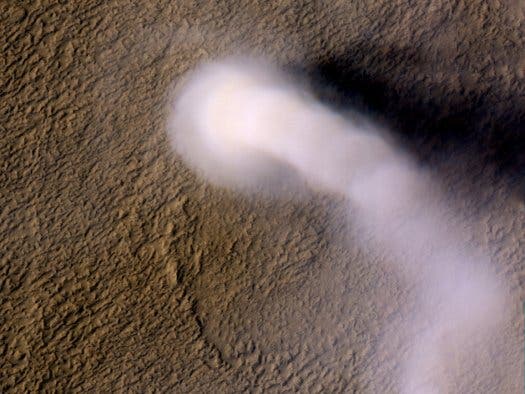 A massive whirling dust storm on the surface of Mars, as seen captured by the Mars Reconnaissance Orbiter. (c) NASA/JPL-Caltech/UA