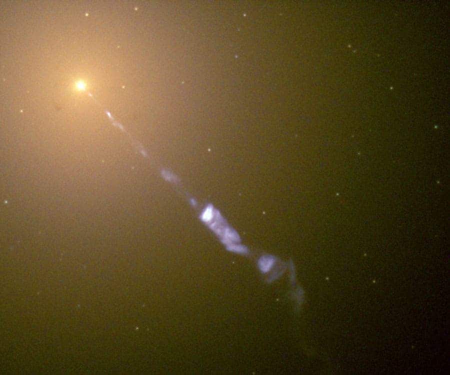 A photo of a huge jet emanating from the center of the galaxy M87, taken by Hubble in 1999, back when there were still very little known about them. The faint dots of light surrounding M87's center are large ancient globular clusters of stars. (c) NASA