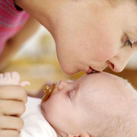 mother-kissing-baby-580x580