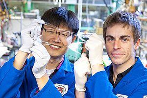 Jeong-Yun Sun (left) and Christoph Keplinger show off an ionically conductive material that is very stretchy and completely transparent. Photo by Eliza Grinnell/SEAS Communications