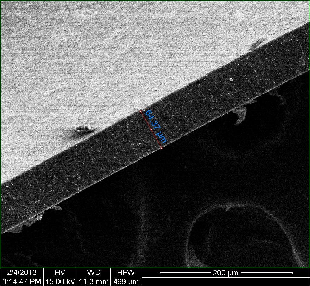 A composite material created at Rice University is nearly impervious to gas and may lead to efficient storage of compressed natural gas for vehicles. A 65-micrometer-wide polymer film, photographed edge-on with an electron microscope, contains a tiny amount of enhanced graphene nanoribbons that present gas molecules a “tortuous path” to escape. (Credit: Changsheng Xiang/Rice University)