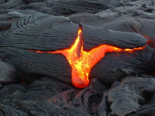 Volcanology is a branch of geology that focuses on volcanoes. This image shows lava flowing out.