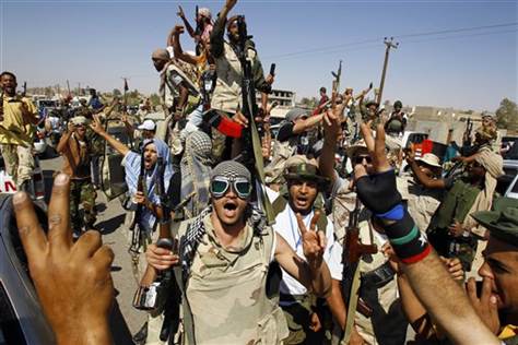 Libyan fighters chants slogans as they take control of Moammar Gadhafi loyalists' villages in the desert some 750 km south of Tripoli, at Gohta, north of the southern city of Sahba on Sunday. Credit: Francois Mori  /  AP