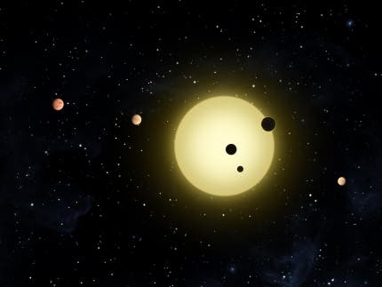 Kepler-11 is a sun-like star around which six planets orbit. At times, two or more planets pass in front of the star at once, as shown in this artist's conception of a simultaneous transit of three planets observed by NASA's Kepler spacecraft on Aug. 26, 2010. Image credit: NASA/Tim Pyle