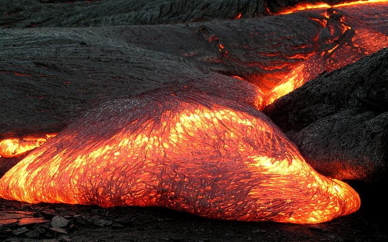 Lava flow on Hawaii. Lava is the extrusive equivalent of magma. Image via Wiki Commons.