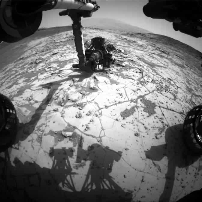 This view from the wide-angle Hazard Avoidance Camera on the front of NASA's Curiosity Mars Rover shows the rover's drill in position for a mini-drill test to assess whether a rock target called 