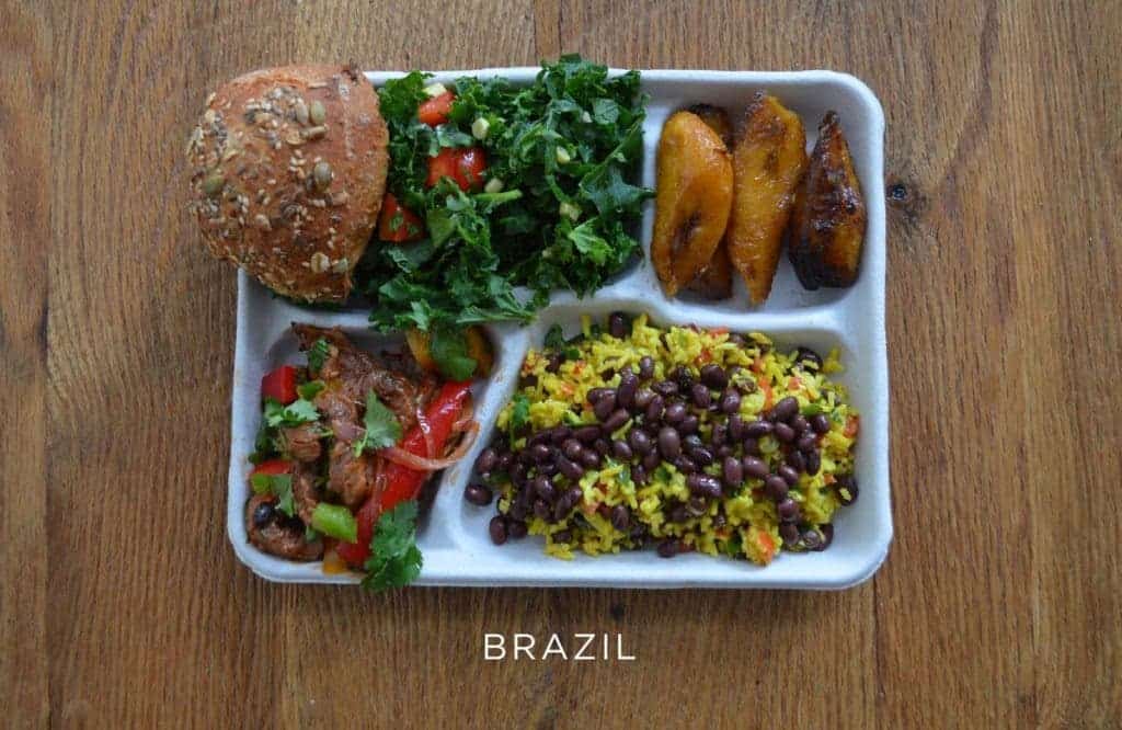 Pork with mixed veggies, black beans and rice, salad, bread and baked plantains.