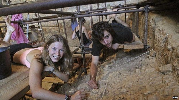 Volunteer archaeologists Camille and Valentin pose for the cameras in the Arago cave. Camille, 16, found the adult tooth, which dates back 565,000 years