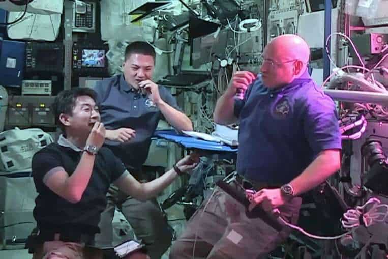 Japan Aerospace Exploration Agency (JAXA) astronaut Kimiya Yui (left), with NASA astronauts Kjell Lindgren (centre) and Scott Kelly (right) as they eat red romaine lettuce grown on board the International Space Station. PHOTO: AFP