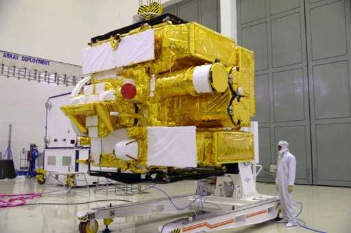 A scientist inspects the Astrosat while it was still seated at the Indian Space Research Organisation (ISRO) Satellite Centre in Bangalore. Image: ISRO