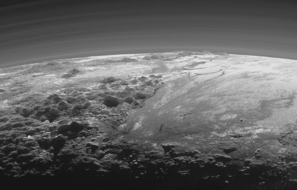 Majestic Mountains and Frozen Plains: Just 15 minutes after its closest approach to Pluto on July 14, 2015, NASA’s New Horizons spacecraft looked back toward the sun and captured this near-sunset view of the rugged, icy mountains and flat ice plains extending to Pluto’s horizon. The smooth expanse of the informally named Sputnik Planum (right) is flanked to the west (left) by rugged mountains up to 11,000 feet (3,500 meters) high. Credits: NASA/JHUAPL/SwRI)