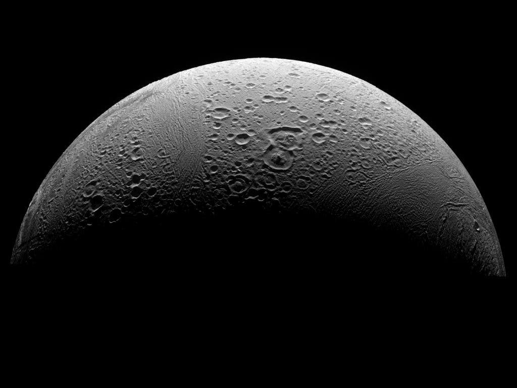 A Cassini mosaic of degraded craters, fractures, and disrupted terrain in Enceladus's north polar region. Image via Wikipedia.