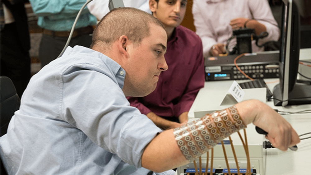 Four years ago, Ian Burkhart lost the ability to move his arms and legs. Now thanks to a neural implant and electrodes on his forearm, he's able to move his wrist, hand, and fingers. Image credits Ohio State University Wexner Medical Center/ Batelle