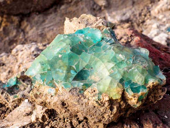 Small fragments of raw glass as they were found at the site. 
Image credits Assaf Peretz / Israel Antiquities Authority.