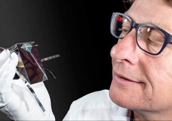Dr Mark Keevers with one of the spectrum splitting, four-junction mini-modules developed at UNSW.