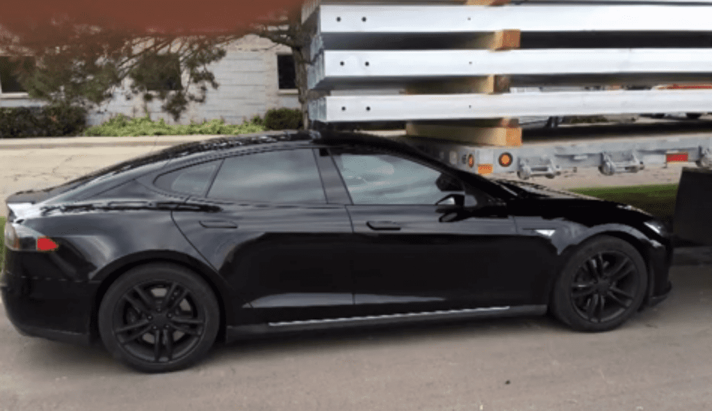 Jared Overton's Tesla Model S slammed into a parked trailer after the summon feature was activated. It's not clear yet if this was a human error or a Tesla bug. Credit: KSL