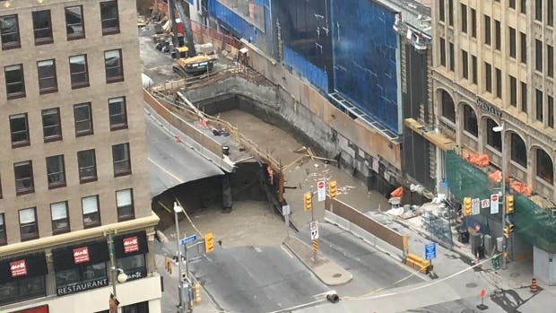 The sinkhole damaged the street and buildings in the area.
Image via reddit