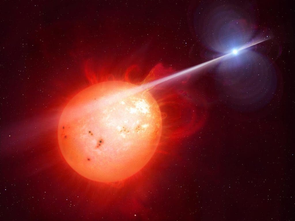 Illustration of the pulsing white dwarf lashing particles and radiation onto its companion red dwarf. Credit: University of Warwick