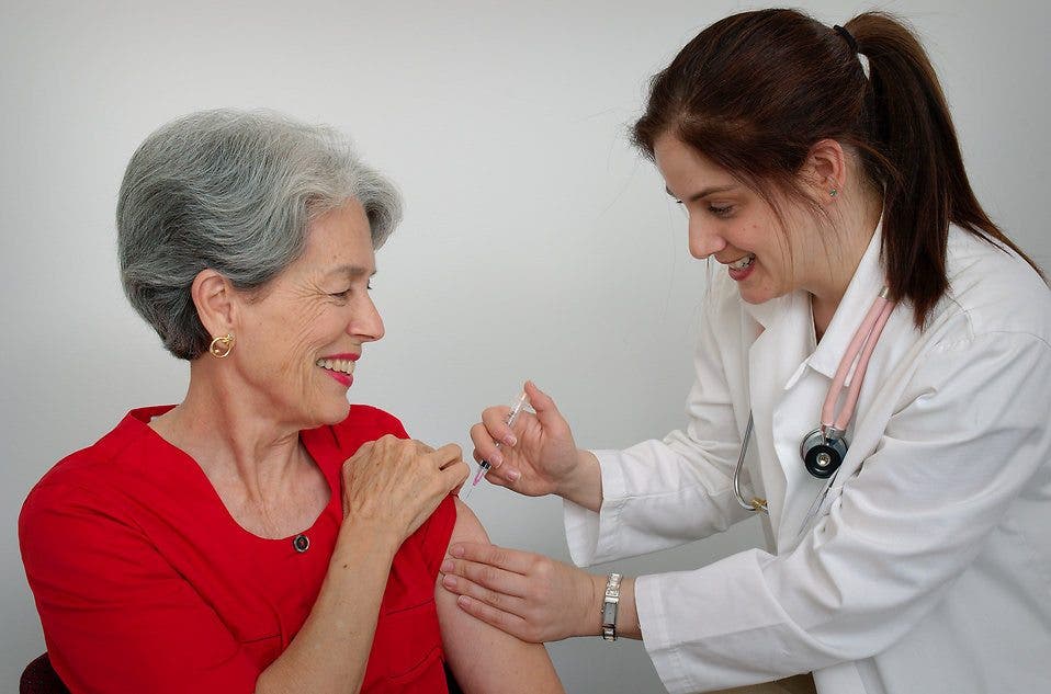 A senior woman receiving a vaccination shot from her doctor -- showing empathy towards patients can go a long way towards making them feel better. Image credits: CDC/ Judy Schmidt