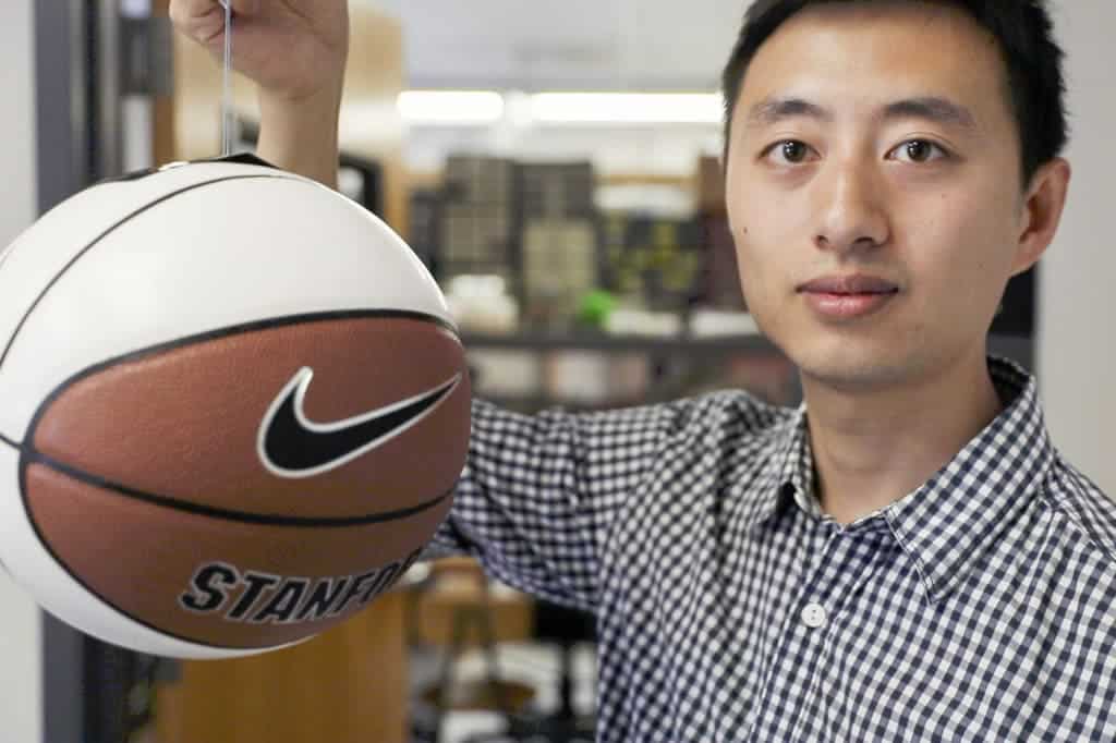 Hao Jiang, graduate student at Stanford shows a basketball being gripped by the gecko-inspired adhesive.