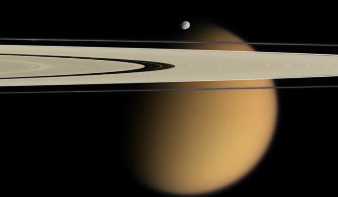 Cassini delivers this stunning vista showing small, battered Epimetheus and smog-enshrouded Titan, with Saturn's A and F rings stretching across the scene. Credit: NASA.