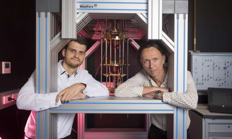 Dr. Guilherme Tosi and Professor Andrea Morello at the UNSW labs with a dilution refrigerator, which cools silicon chips down to 0.01 K above absolute zero. Credit: Quentin Jones/UNSW .