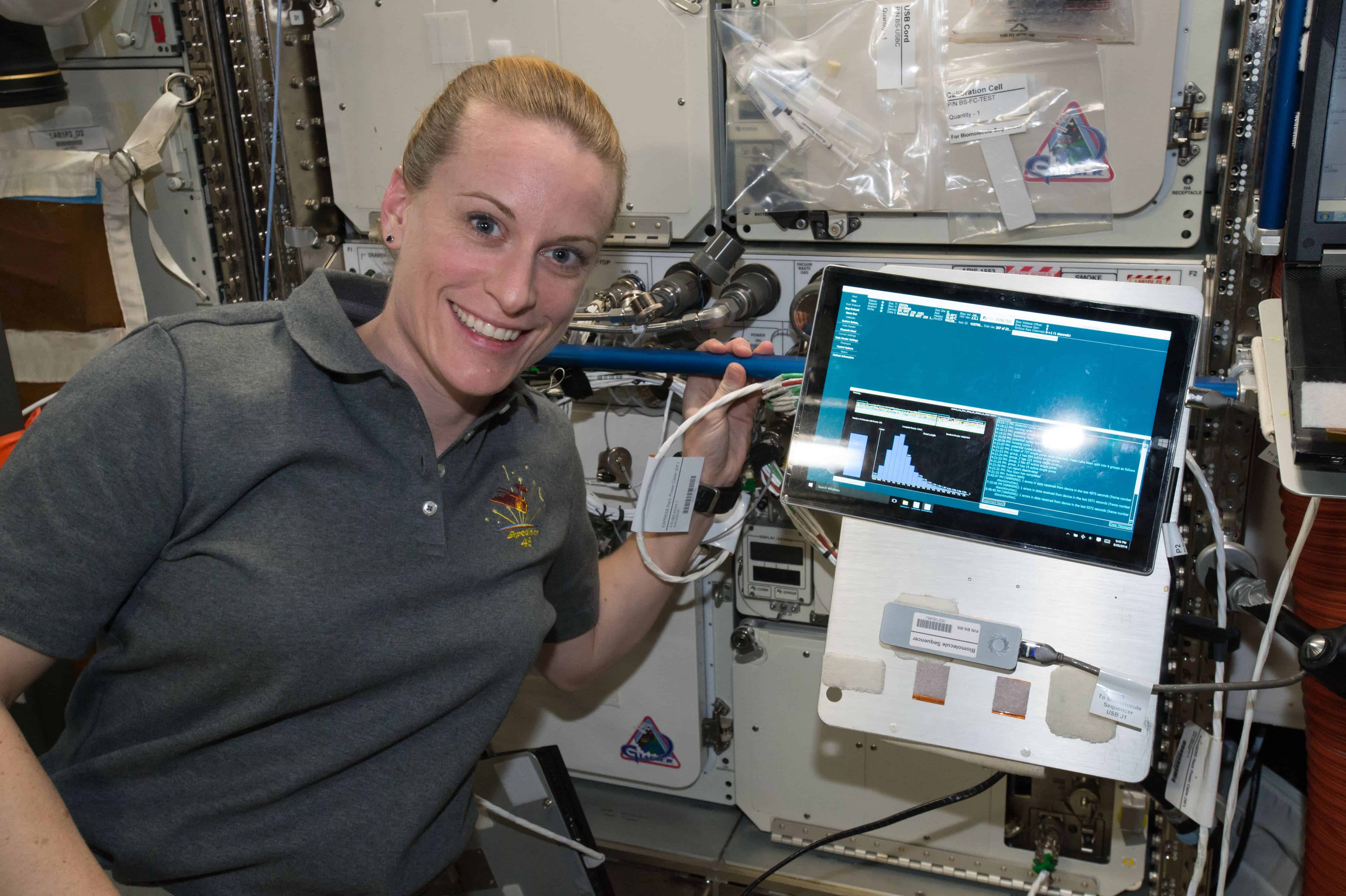 NASA astronaut Kate Rubins poses for a picture during the first sample initialization run of the Biomolecular Sequencer investigation. Credits: NASA.