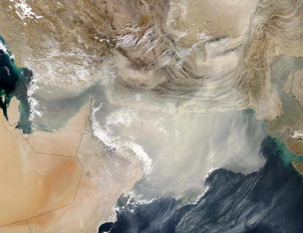 Satellite image of a dust storm blowing large quantities of dust out over the Persian Gulf and Arabian Sea on Saturday, December 13, 2003. Viruses can travel for thousands of miles by riding dust particles and water vapor. Credit: NASA.