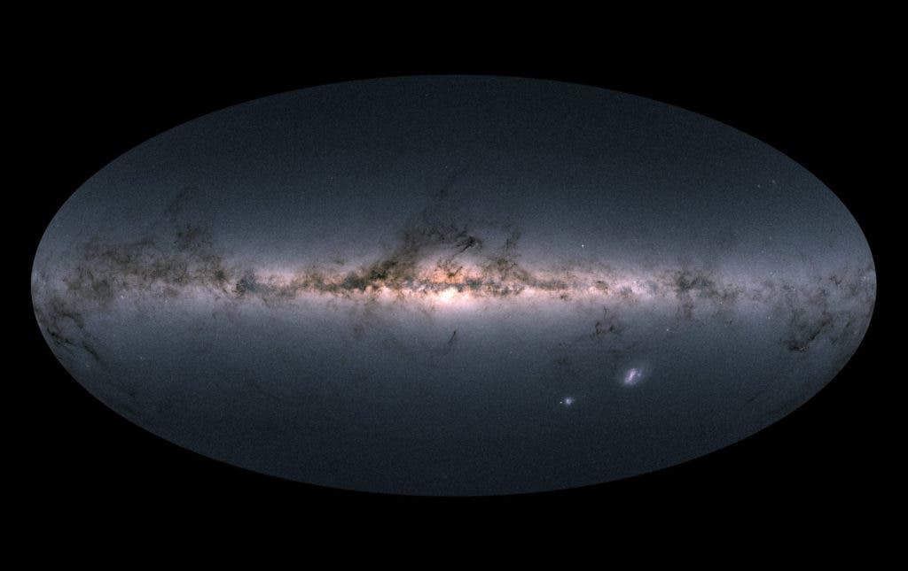 The map shows the total brightness and colour of stars observed by the ESA satellite in each portion of the sky between July 2014 and May 2016. Brighter regions indicate denser concentrations of especially bright stars, while darker regions correspond to patches of the sky where fewer bright stars are observed. Credit: Gaia Data Processing and Analysis Consortium (DPAC).