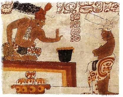 A possible Maya lord sits before an individual with a container of frothed chocolate. Image via Wikipedia.