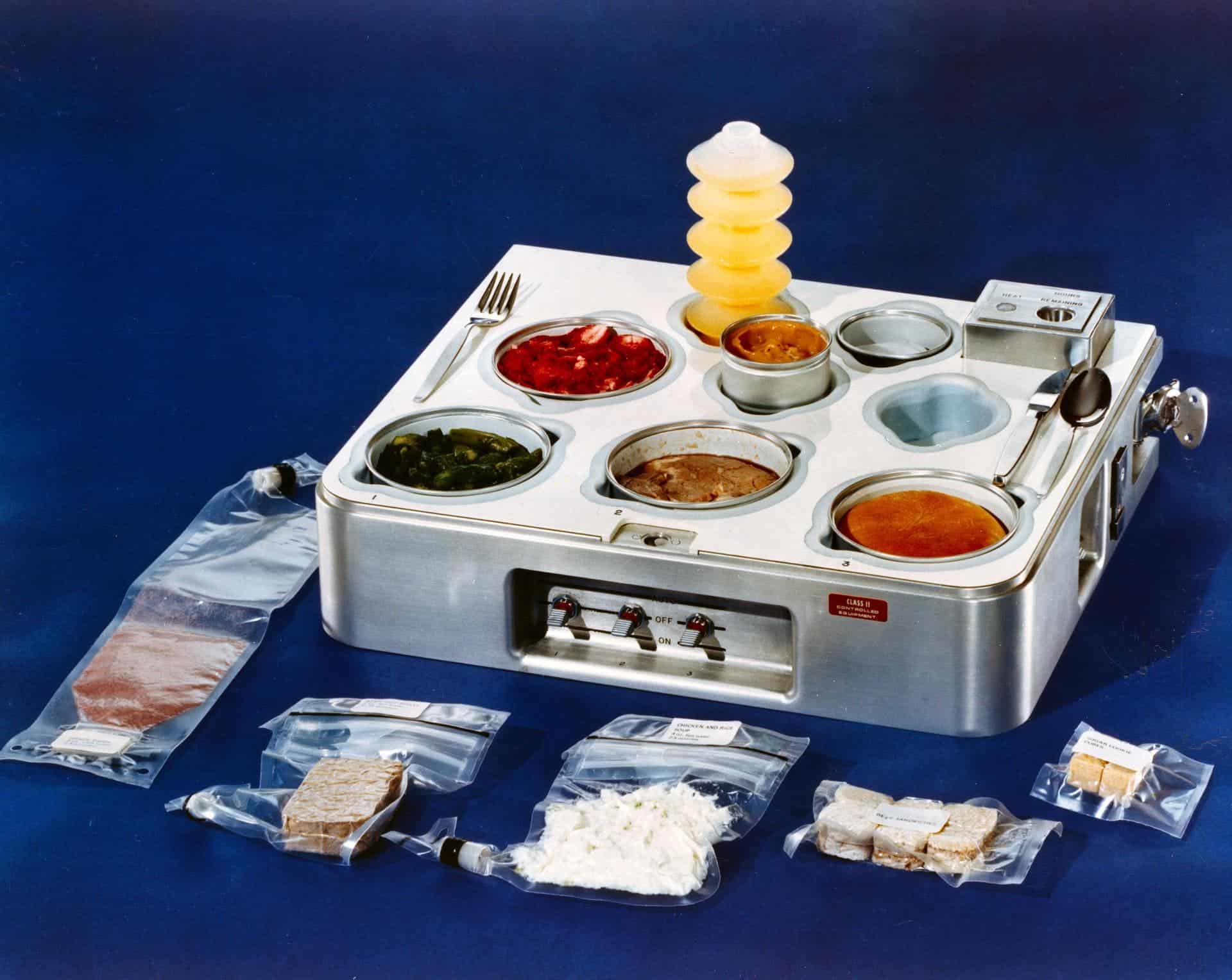 Astronaut food during the Skylab days in the 1970s: grape drink, beef pot roast, chicken and rice, beef sandwiches and sugar cookie cubes, orange drink, strawberries, asparagus, prime rib, dinner roll and butterscotch pudding. Credit: NASA.
