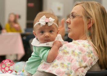 A mom and her baby receive donated items during Operation Baby Shower this past week on Joint Base McGuire-Dix-Lakehurst, N.J. More than $35,000 in donations were distributed to 71 military mothers. (U.S. Army photo by Sgt. 1st Class Raymond Moore/Released)