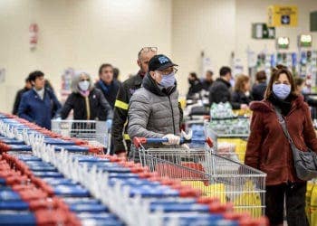 People wear masks at a supermarket in Milan, Italy, Sunday, March 8, 2020. Italy announced a sweeping quarantine early Sunday for its northern regions, igniting travel chaos as it restricted the movements of a quarter of its population in a bid to halt the new coronavirus' relentless march across Europe. (Claudio Furlan/LaPresse via AP)