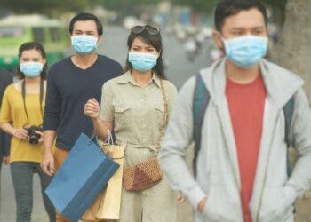 Citizens walking on the street in masks because of danger of epidemic