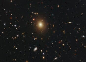 The  giant elliptical galaxy in the centre of this image, taken by the  NASA/ESA Hubble Space Telescope, is the most massive and brightest  member of the galaxy cluster Abell 2261. Astronomers refer to it as the brightest cluster galaxy (BCG). Spanning a little over one million light-years, the galaxy is about 20 times the diameter of  our Milky Way galaxy. Astronomers  used Hubble's Advanced Camera for Surveys and Wide Field Camera 3 to  measure the amount of starlight across the galaxy, catalogued as 2MASX  J17222717+3207571 but more commonly called A2261-BCG (short for Abell  2261 brightest cluster galaxy). Abell 2261 is located three billion  light-years away. The  observations were taken between March and May 2011. The Abell 2261  cluster is part of a multi-wavelength survey called the Cluster Lensing  And Supernova survey with Hubble (CLASH).