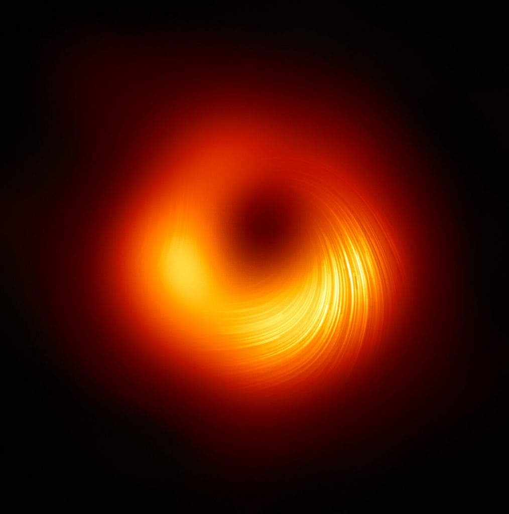 The Event Horizon Telescope (EHT) collaboration, who produced the first ever image of a black hole released in 2019, has today a new view of the massive object at the centre of the Messier 87 (M87) galaxy: how it looks in polarised light. This is the first time astronomers have been able to measure polarisation, a signature of magnetic fields, this close to the edge of a black hole. (EHT Collaboration)