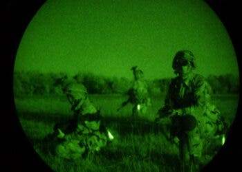 A night vision scope view of US Air Force (USAF) members of the 820th Security Forces Group (SFG), after parachuting in, securing an area at Avon Park Air Force Range, Florida (FL), at the start of SAFE FLAG exercise.