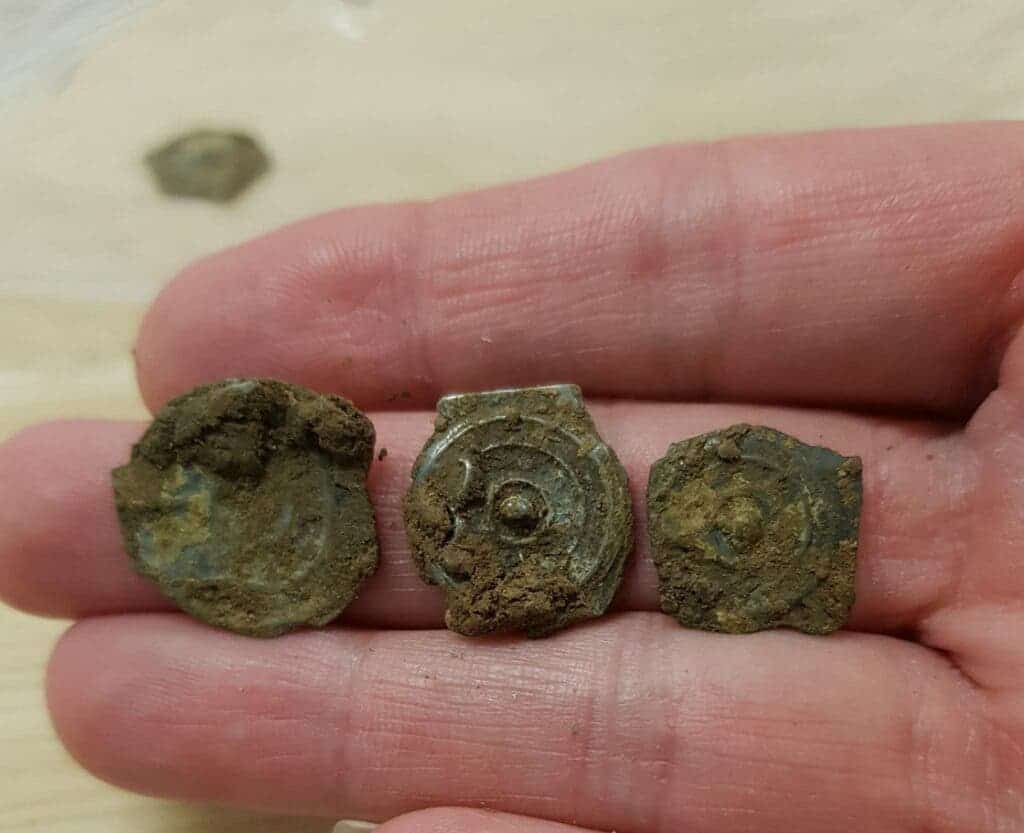 hand holding ancient coins