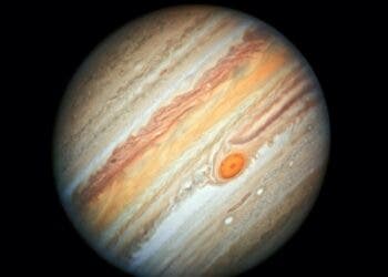 Jupiter is the king of the solar system, more massive than all of the other solar-system planets combined. Although astronomers have been observing the gas-giant planet for hundreds of years, it still remains a mysterious world.

Astronomers don't have definitive answers, for example, of why cloud bands and storms change colors, or why storms shrink in size. The most prominent long-lasting feature, the Great Red Spot, has been downsizing since the 1800s. However, the giant storm is still large enough to swallow Earth.

The Red Spot is anchored in a roiling atmosphere that is powered by heat welling up from the monster planet’s deep interior, which drives a turbulent atmosphere. In contrast, sunlight powers Earth's atmosphere. From Jupiter, however, the Sun is much fainter because the planet is much farther away from it. Jupiter's upper atmosphere is a riot of colorful clouds, contained in bands that whisk along at different wind speeds and in alternating directions. Dynamic features such as cyclones and anticyclones (high-pressure storms that rotate counterclockwise in the southern hemisphere) abound.

Attempting to understand the forces driving Jupiter's atmosphere is like trying to predict the pattern cream will make when it is poured into a hot cup of coffee. Researchers are hoping that Hubble's yearly monitoring of the planet—as an interplanetary weatherman—will reveal the shifting behavior of Jupiter's clouds. Hubble images should help unravel many of the planet's outstanding puzzles. This new Hubble image is part of that yearly study, called the Outer Planets Atmospheres Legacy program, or OPAL.