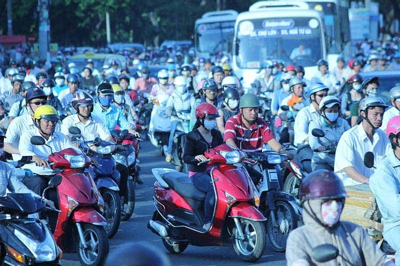 Crowded Asian overpopulated streets packed with scooters