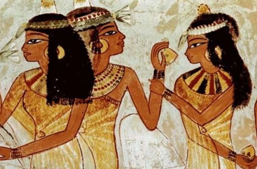 An ancient Egyptian mural showing three female figures sharing and smelling different kinds of foods. 