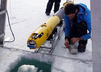 Scientists deploying the Icefin robot in Antarctica.