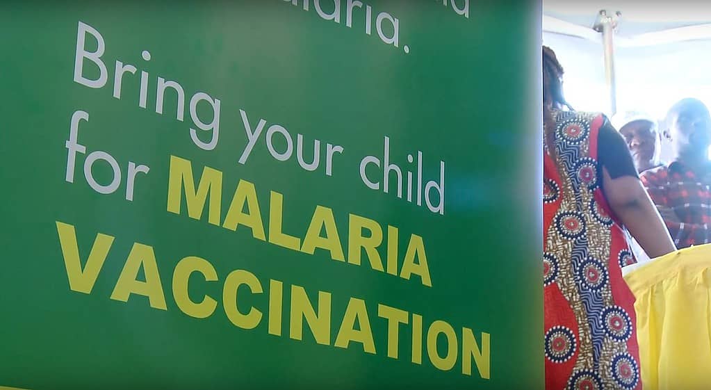 A sign asks people to bring their children for malaria vaccination