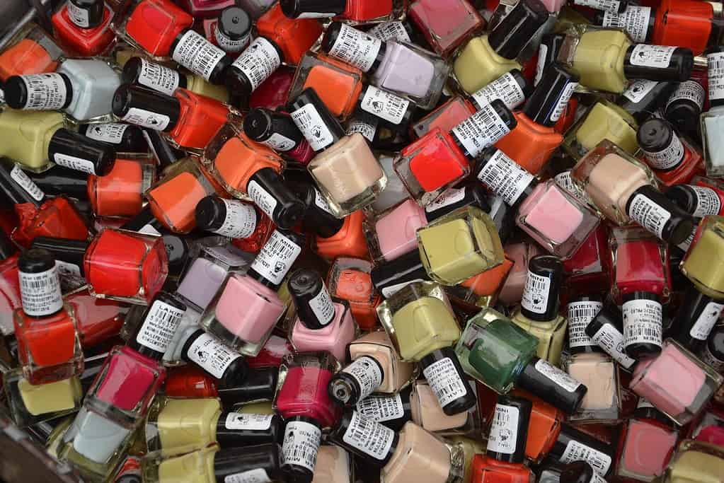Closeup of a bunch of nail polish bottles. 