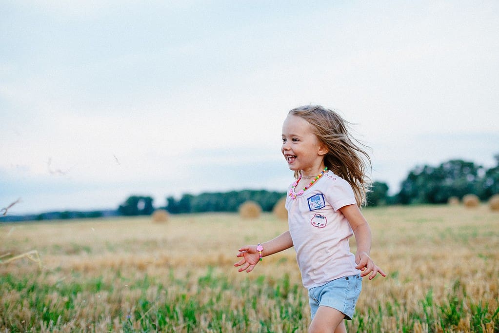 Young girl happy in a field.